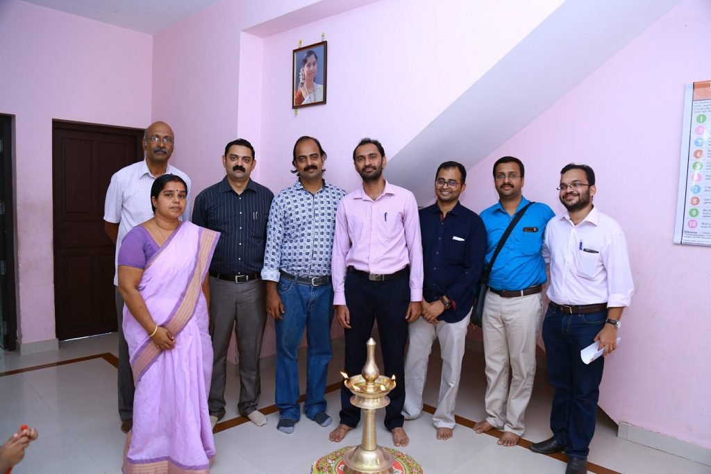 Members of the society at the guidance centre beneath Dr. Vimi's portrait